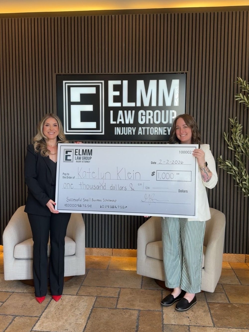 Katelyn Klein receiving the Elmm Law Group Successful Small Business Scholarship check for $1,000
